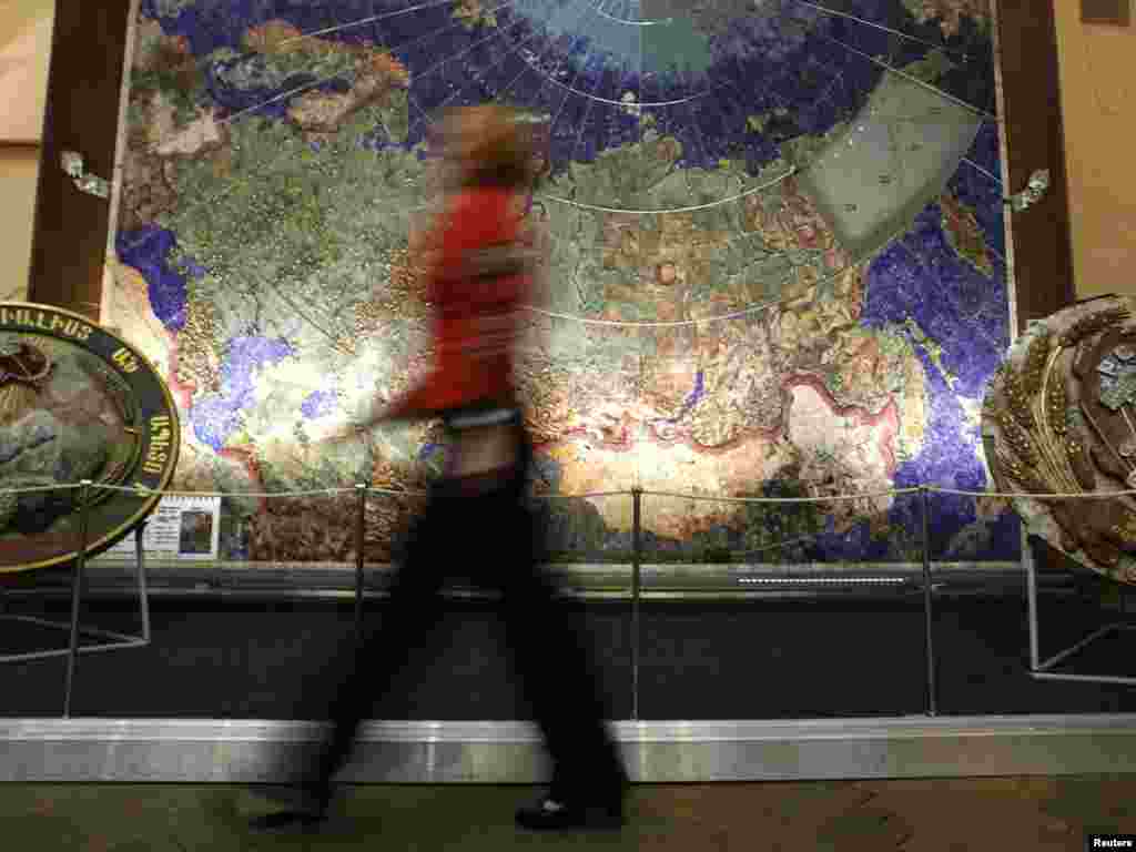 A visitor walks past a map of the USSR studded with semiprecious stones at a geological exploring museum in St. Petersburg on November 14. (REUTERS/Alexander Demianchuk)