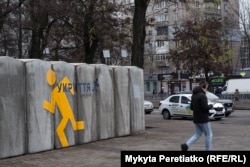 A man walks past an above-ground shelter in Dnipro minutes before an air-raid siren on December 11.