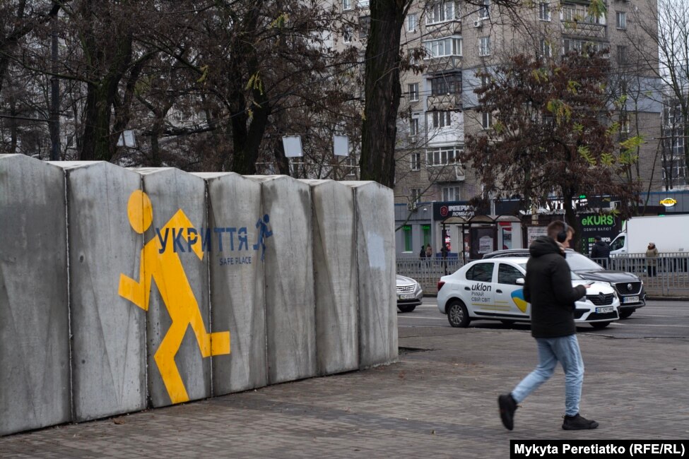 A man walks past an above-ground shelter in Dnipro minutes before an air-raid siren on December 11.