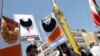 Demonstrators hold images of US President Donald Trump and Israeli Prime Minister Benjamin Netanyahu adorned with Islamist-inspired bears during a rally marking Quds Day in Tehran