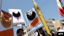 Demonstrators hold images of US President Donald Trump and Israeli Prime Minister Benjamin Netanyahu adorned with Islamist-inspired bears during a rally marking Quds Day in Tehran