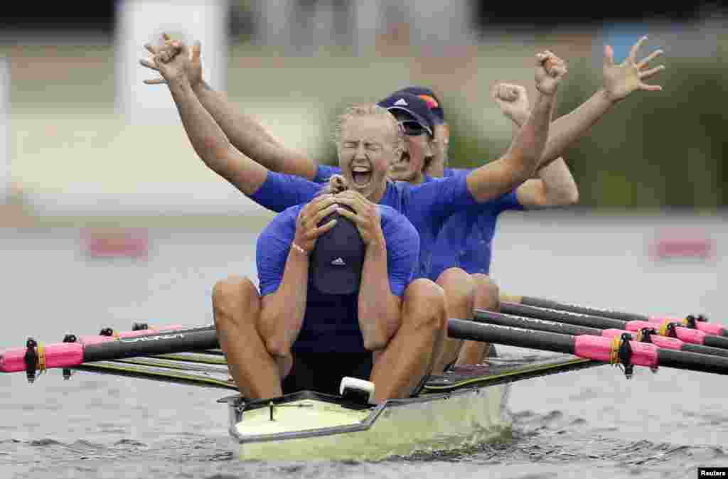 Yana Dementieva (front), Anastasiia Kozhenkova, Nataliya Dovgodko, and Kateryna Tarasenko of Ukraine celebrate after winning gold in the women's quadruple sculls during the Summer Olympics. (Reuters/Natacha Pisarenko)