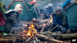 Migrants gather in a tent camp on the Belarusian-Polish border.