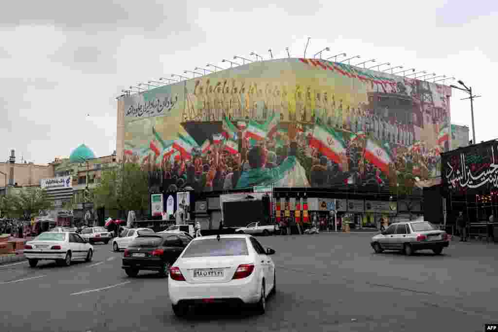 A memorial billboard in central Tehran depicts crew members of the Iranian warship IRIS Dena, which was sunk by a US Navy submarine in the Indian Ocean on March 4.