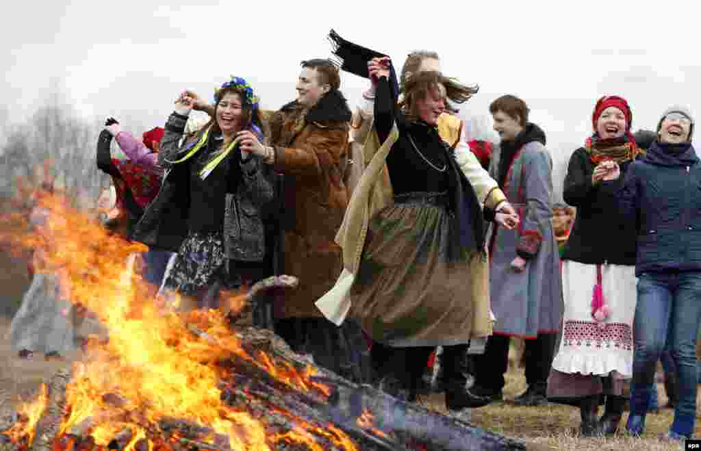 Participants wearing traditional costumes dance as they celebrate the national rite Gukanne Vyasny (Spring Welcoming) near the village of Aziarco in the Minsk region. (epa/Tatyana Zenkovich)