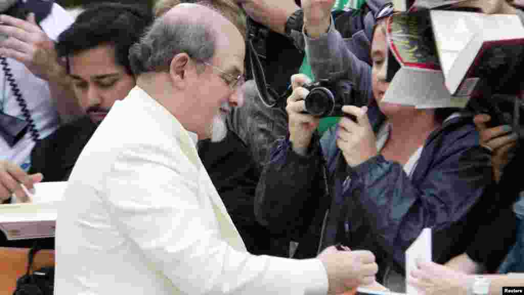 Rushdie signs autographs as he arrives for a festival showing in Toronto, Canada, in September 2012 of the film &quot;Midnight&#39;s Children,&quot; based on his Booker Prize-winning book from 1981.