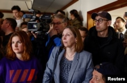 People, including U.S. Ambassador to Russia Lynne Tracy (center), gathered in a court building to hear the verdict on April 17.