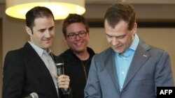 Russian President Dmitry Medvedev sends his first tweet as Twitter co-founders Biz Stone (center) and Evan Williams look on at Twitter headquarters in San Francisco.