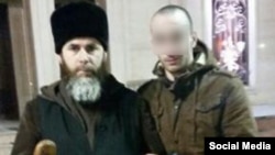 Said Mazhayev (right), a Chechen who returned home purportedly after six months fighting in Syria and was touted in Russian media as a repentant former Islamic State (IS) militant, shown with a Chechen mufti.