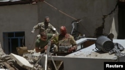 A wounded Italian soldier is helped after a blast near an Italian base in Herat.