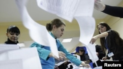 Electoral officials count ballots at a polling station in the capital, Chisinau.