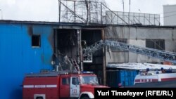 Firefighters inspect the aftermath of the blaze at a Moscow market that killed at least 17 people.