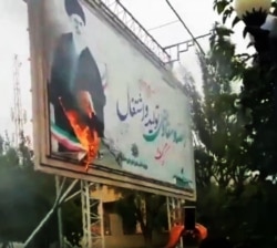 A billboard with a big picture of Supreme Leader Ali Khamenei, has been set on fire in the recent protests in Iran.