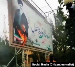 A billboard with a big picture of Supreme Leader Ali Khamenei, has been set on fire in the recent protests in Iran.