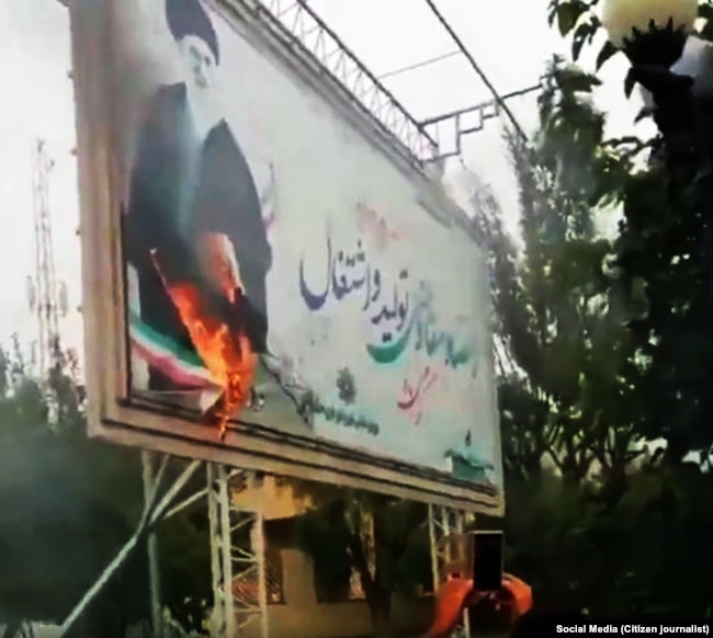 A billboard with a big picture of Supreme Leader Ali Khamenei, has been set on fire in the recent protests in Iran.