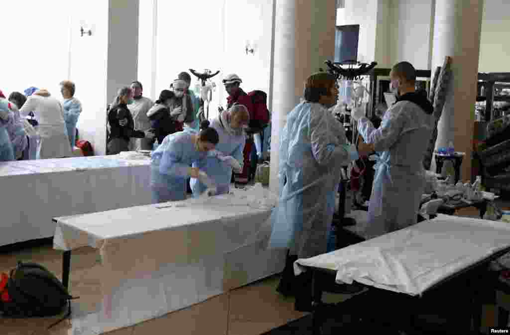 Medical personnel prepare an improvised field hospital in the lobby of the Ukraine Hotel.