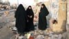 Iraqi women gather at the site of a blast at the Mraidi market in Baghdad's Sadr City.