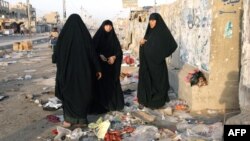 Iraqi women gather at the site of a blast at the Mraidi market in Baghdad's Sadr City.