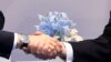 U.S. President Donald Trump (right) and Russia&#39;s President Vladimir Putin shake hands during a meeting on the sidelines of the Group of 20 summit in Hamburg, Germany, on July 7. (AFP/Saul Loeb)