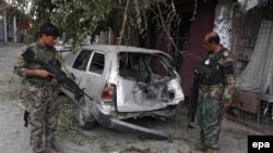 Members of the Afghan security forces inspect a vehicle on July 26 that was damaged during an operation against Islamic States (IS) militants in Kot district of Nangarhar province.