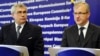 Bosnian Foreign Minister Sven Alkalaj (left) and EU Enlargement Commissioner Olli Rehn speak to reporters in Brussels.