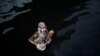 A man bathes in the polluted water of the Yamuna River on a hot day in New Delhi. (Reuters/Adnan Abidi)