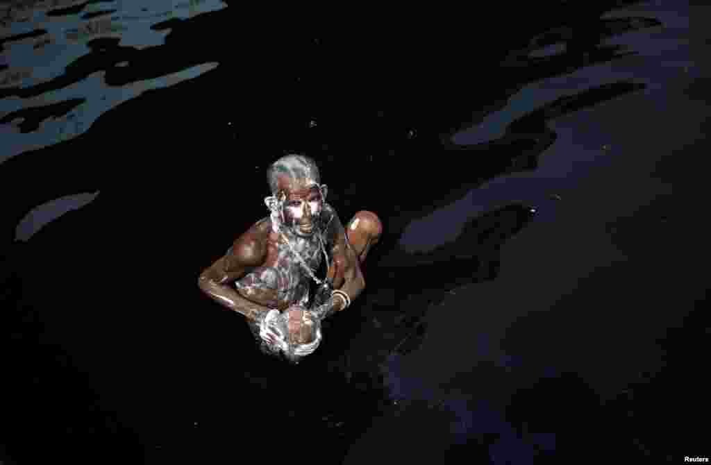 A man bathes in the polluted water of the Yamuna River on a hot day in New Delhi. (Reuters/Adnan Abidi)
