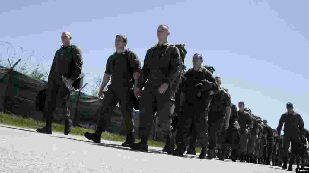 NATO peacekeepers from Austria march together after arriving at Djakovica Airport in Kosovo on April 27. (Reuters/Hazir Reka)