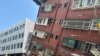 Firefighters work at the site where a building collapsed following the earthquake, in Hualien