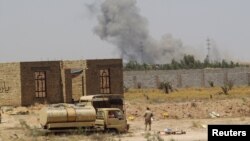 Smoke rises from clashes near Fallujah on May 30.