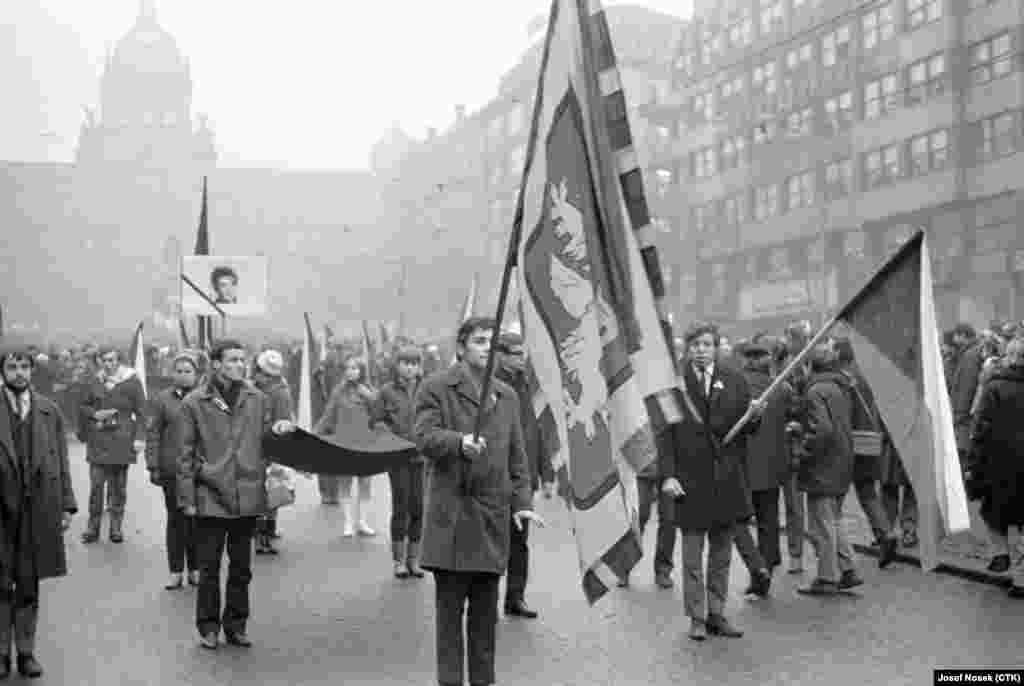 Students carry flags and a picture of Palach during a march in Prague on January 20, 1969.