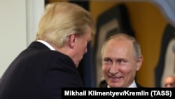 U.S. President Donald Trump and Russian President Vladimir Putin talk before a session of the APEC summit in Vietnam last year. 