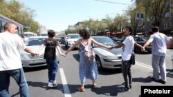 Armenia - Activists block a street in Yerevan in protest against a controversial construction project, 22Aug2013.