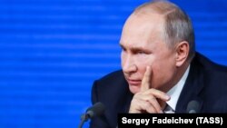 Russian President Vladimir Putin gestures during his annual news conference in Moscow on December 20.