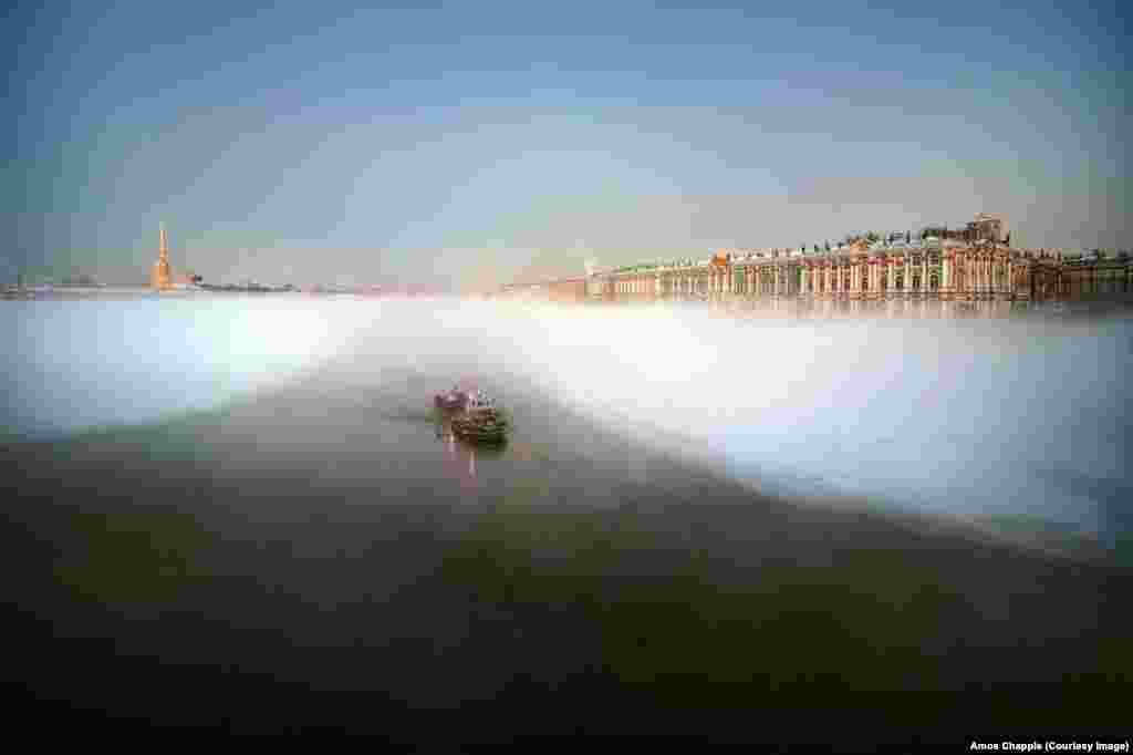 Winter mist flowing on the River Neva as a tugboat heads to sea.