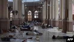 Pakistani Muslims rest at a mosque during a heatwave in Karachi on June 22.