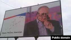 Запачканный краской билборд с изображением президента России Владимира Путина. Керчь, сентябрь 2015 года