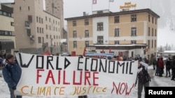 Aktivisti za klimu pokazuju transparent tokom protesta uoči Svetskog ekonomskog foruma u alpskom mestu Davos, Švajcarska, 15. januara 2023. 