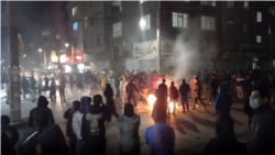 Protesters light a fire on the streets of Karaj amid anti-government protests in Iran on January 8. 