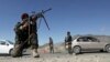 Afghan National Army soldiers stand guard at a checkpoint on the outskirts of Kabul on April 17.