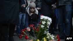 People place flowers and light candles in memory of victims of the blast in the St. Petersburg metro outside Sennaya Square station on April 3.