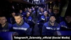 Ukrainian prisoners of war released as part of the latest swap with Russia ride a bus on December 30.