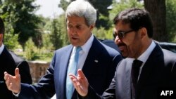 U.S. Secretary of State John Kerry (left) talks to Afghanistan's Acting Foreign Minister Zarar Ahmad Osmani in Kabul.