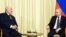 Russian President Vladimir Putin (right) meets with Belarusian ruler Alyaksandr Lukashenka outside Moscow on February 17.