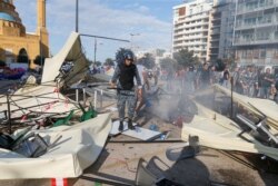Lebanese police stand near destroyed tents, that were set-up by anti-government protesters in Beirut, Lebanon October 29, 2019