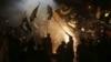 Pakistanis in Hyderabad wave flags as they celebrate after a cease-fire between Pakistan and India.