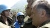 General Ratko Mladic (right) confers with Dutch peacekeepers in Srebrenica in July 1995.