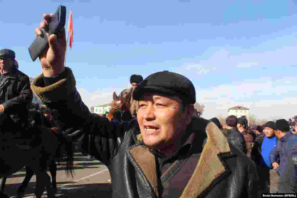 A numbers of protesters stood and chanted. Some threw stones, and at least one burned a portrait of Kyrgyzstan&#39;s president, Almazbek Atambaev.&nbsp;