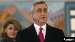 Armenia -- President Serzh Sarkisian and his wife Rita leave a polling station after voting during the presidential election in Yerevan, 18feb2013