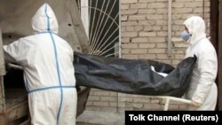 Medics outside a hospital morgue in Barnaul. “The Health Ministry has reclassified a large portion of the COVID-19 fatalities to other causes,” says Russian demographer Aleksei Raksha.